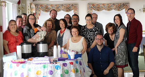 A group of church members posing for a photo at a Church Anniversary Celebration.